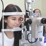 Patient undergoing comprehensive eye screening with a slit-lamp exam at Shinagawa Lasik & Aesthetics.