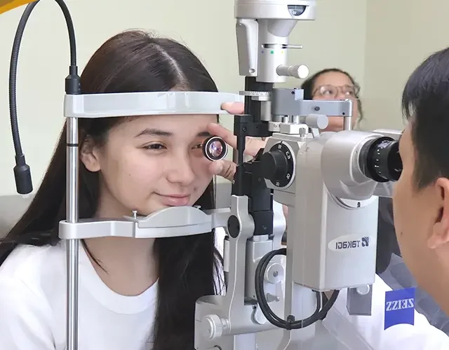 Patient undergoing comprehensive eye screening with a slit-lamp exam at Shinagawa Lasik & Aesthetics.