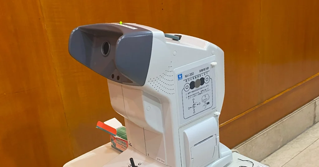 A white and gray machine positioned on a table, emphasizing its functional design and technological elements.