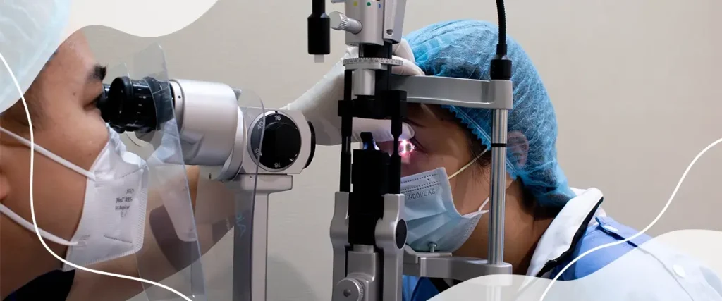 Eye doctor performing a slit-lamp examination on a patient to diagnose vision problems like compound myopic astigmatism