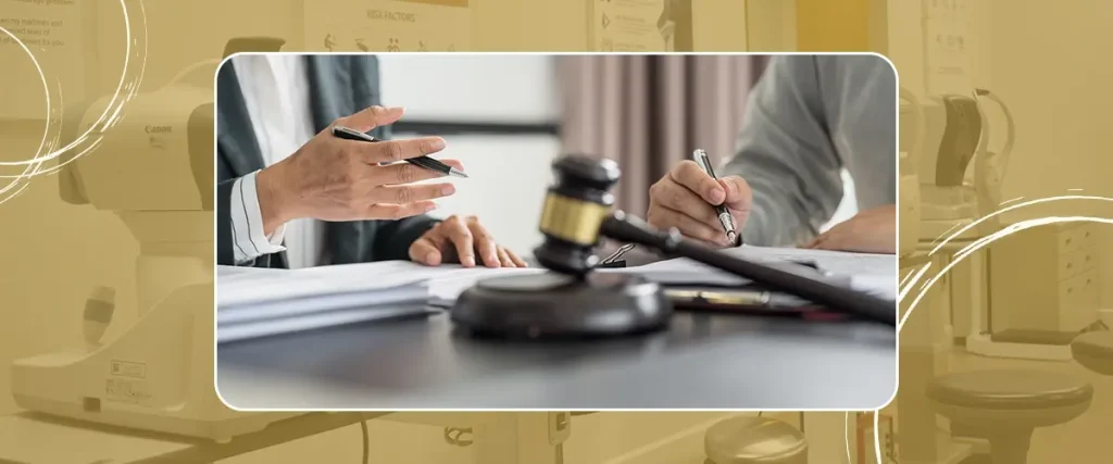 Close-up of two people reviewing legal documents with a judge’s gavel in the foreground, symbolizing legal consultation or compliance discussion