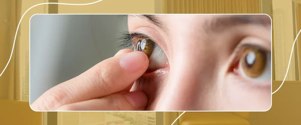 Close-up of a person inserting a contact lens onto their eye, demonstrating vision correction for refractive errors like astigmatism or myopia