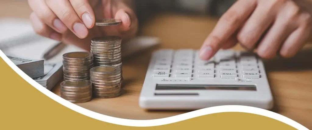 Person calculating LASIK surgery payment plan with coins and calculator at Shinagawa Lasik & Aesthetics in the Philippines
