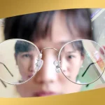 Close-up of person holding eyeglasses with blurred reflection, highlighting vision problems before LASIK at Shinagawa Lasik & Aesthetics Philippines