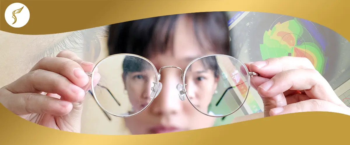 Close-up of person holding eyeglasses with blurred reflection, highlighting vision problems before LASIK at Shinagawa Lasik & Aesthetics Philippines