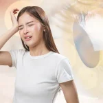Woman experiencing eye pain and headache, showing possible symptoms of keratoconus-related eye strain or migraines