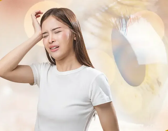 Woman experiencing eye pain and headache, showing possible symptoms of keratoconus-related eye strain or migraines
