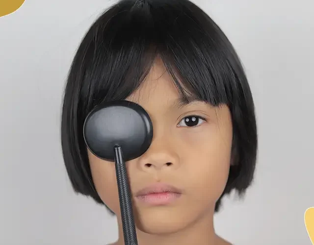 Child covering one eye during a pediatric vision screening or eye exam.
