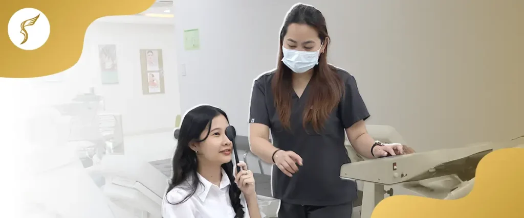 Female patient covering one eye during vision test with optometrist in clinic.